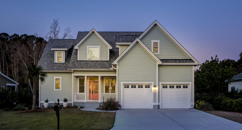 Front elevation of beautiful home lit up at twilight.